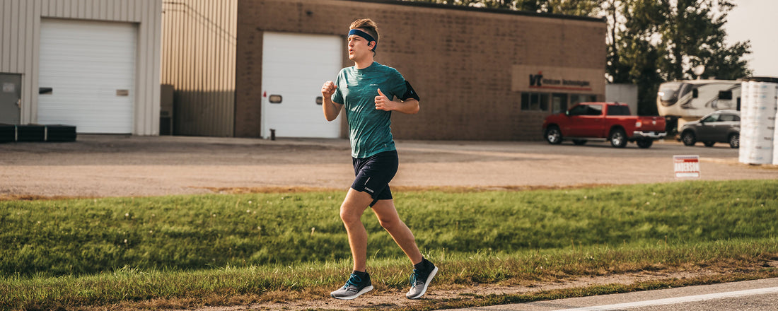 Outside Safe Space founder Mikah Meyer running across Minnesota wearing AfterShokz