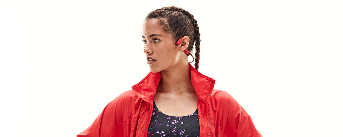 Woman wearing AfterShokz Aeropex wireless headphone