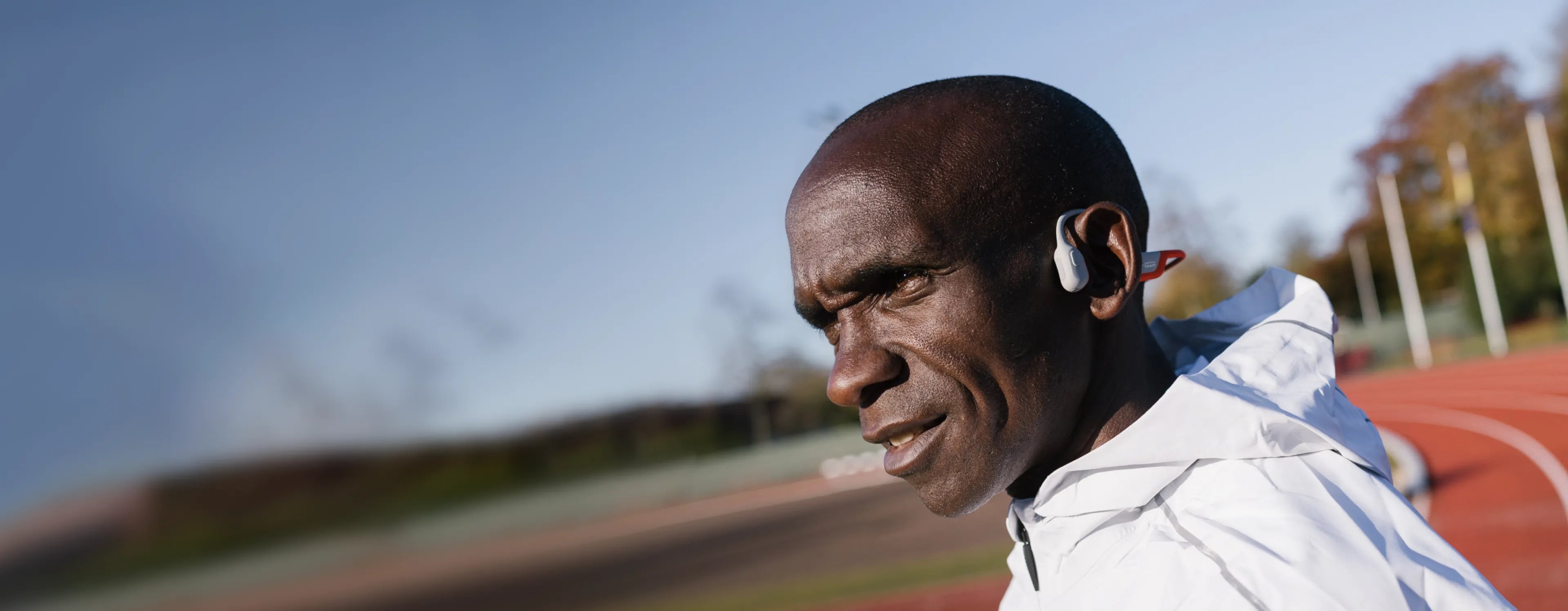 Eliud Kipchoge wears Shokz sports headphones, known for their comfort, lightweight design, and safety.