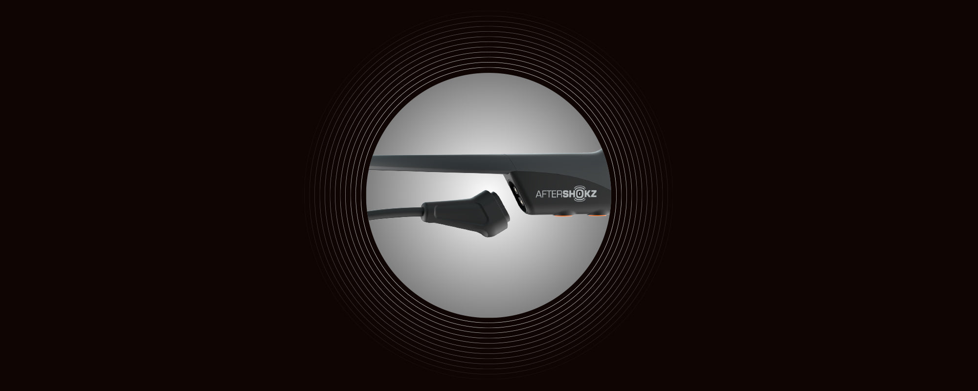 Image of the Magnetic Induction charging port on AfterShokz Aeropex headphones