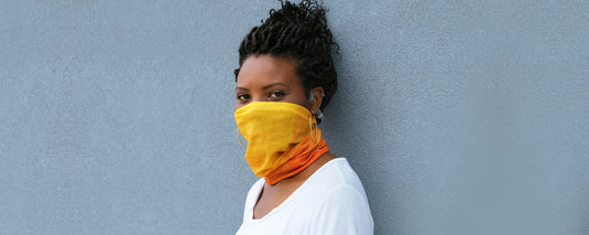 Woman wearing AfterShokz Multifunctional Headwear as face covering