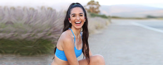 Runner Kim Clark wearing AfterShokz Aeropex wireless headphones