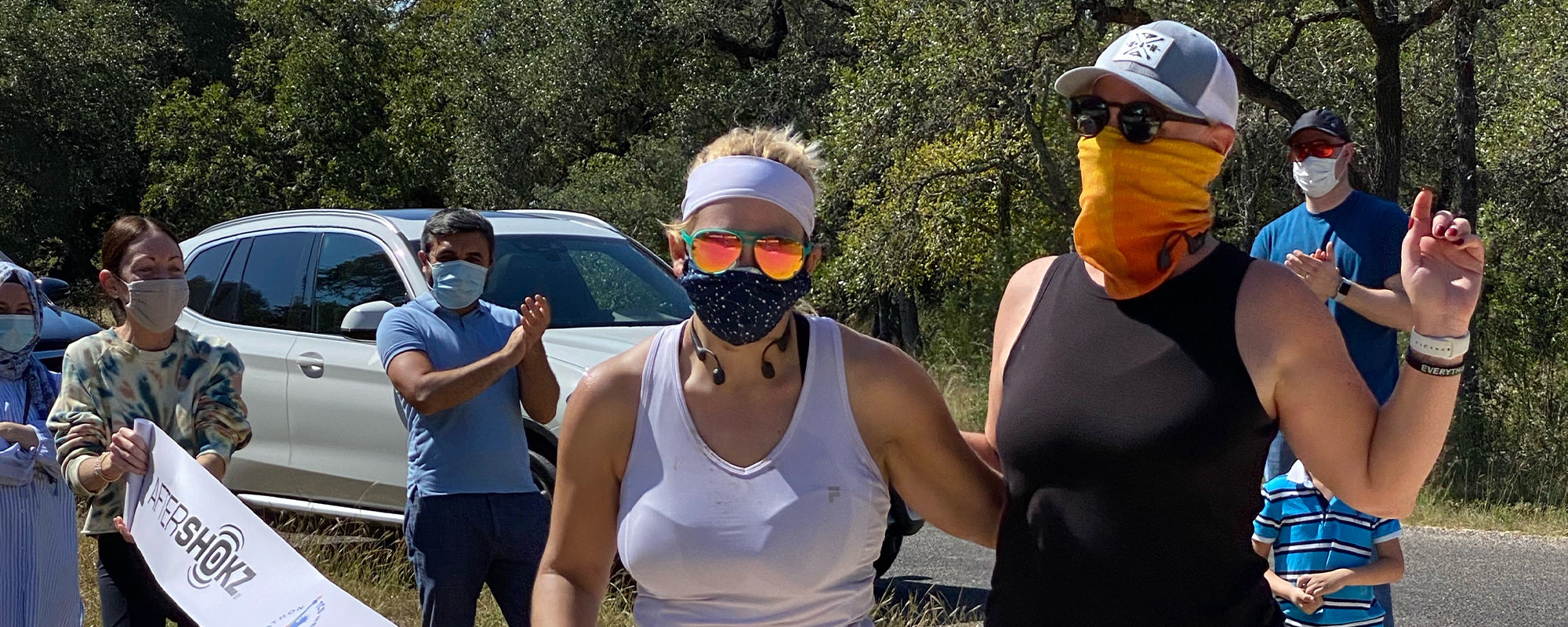 Kristen (left) and AfterShokz VP Kim Fassetta (right) after crossing the virtual race finish line