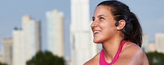 Paralympian Lacey Henderson wearing AfterShokz Aeropex headphones
