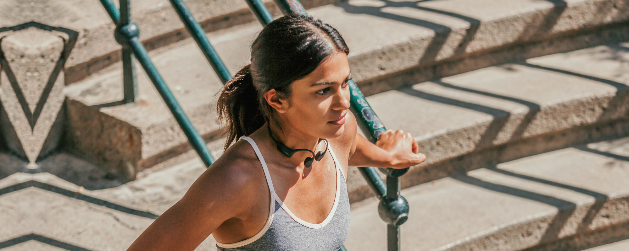 Woman doing outdoor workout wearing AfterShokz Aeropex wireless headphones