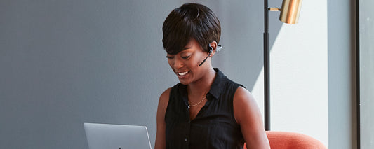 Woman on video call wearing OpenComm headset