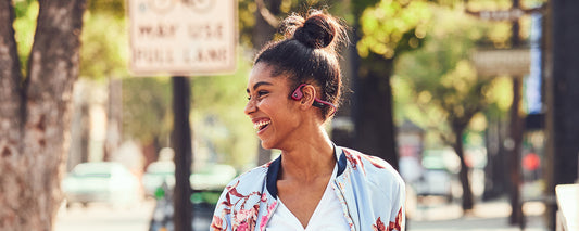 Woman commuting while wearing AfterShokz Air headphones