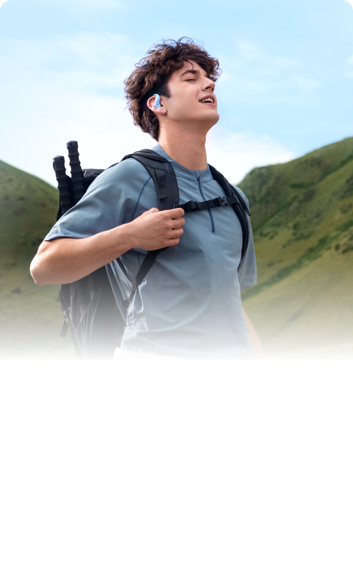 A Hiker Wearing Shokz OpenFit Air 2 Open-ear Headphones Built for Motion, Featuring A Skin-friendly Design.